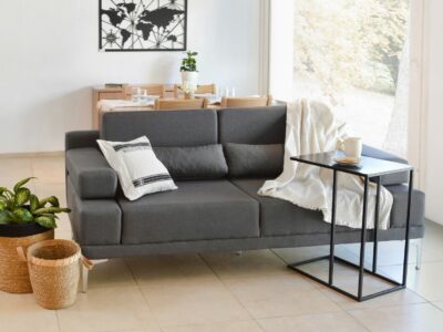 modern living room with grey sofa, side table, and minimalist decor