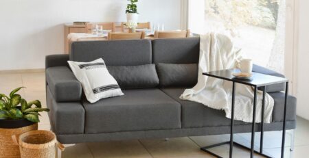 modern living room with grey sofa, side table, and minimalist decor