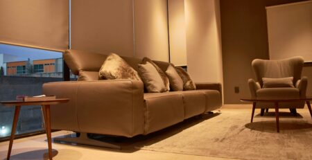 Modern living room with leather sofa, accent chair and neutral décor