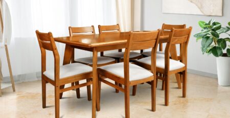 Wooden dining table and chairs set in bright modern dining room